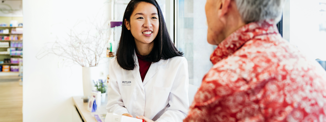A young Butler University pharmacist speaks with a patient.