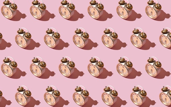 A graphic design of a series of analog alarm clocks on a pink background.