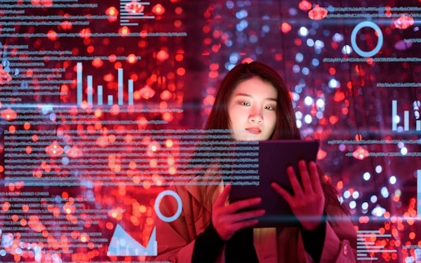 A young woman holds a tablet against a background of graphic charts and text.