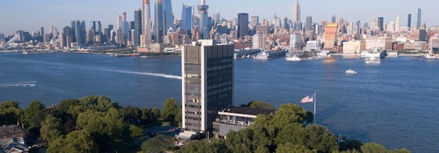 Riverfront view of New York City skyline.